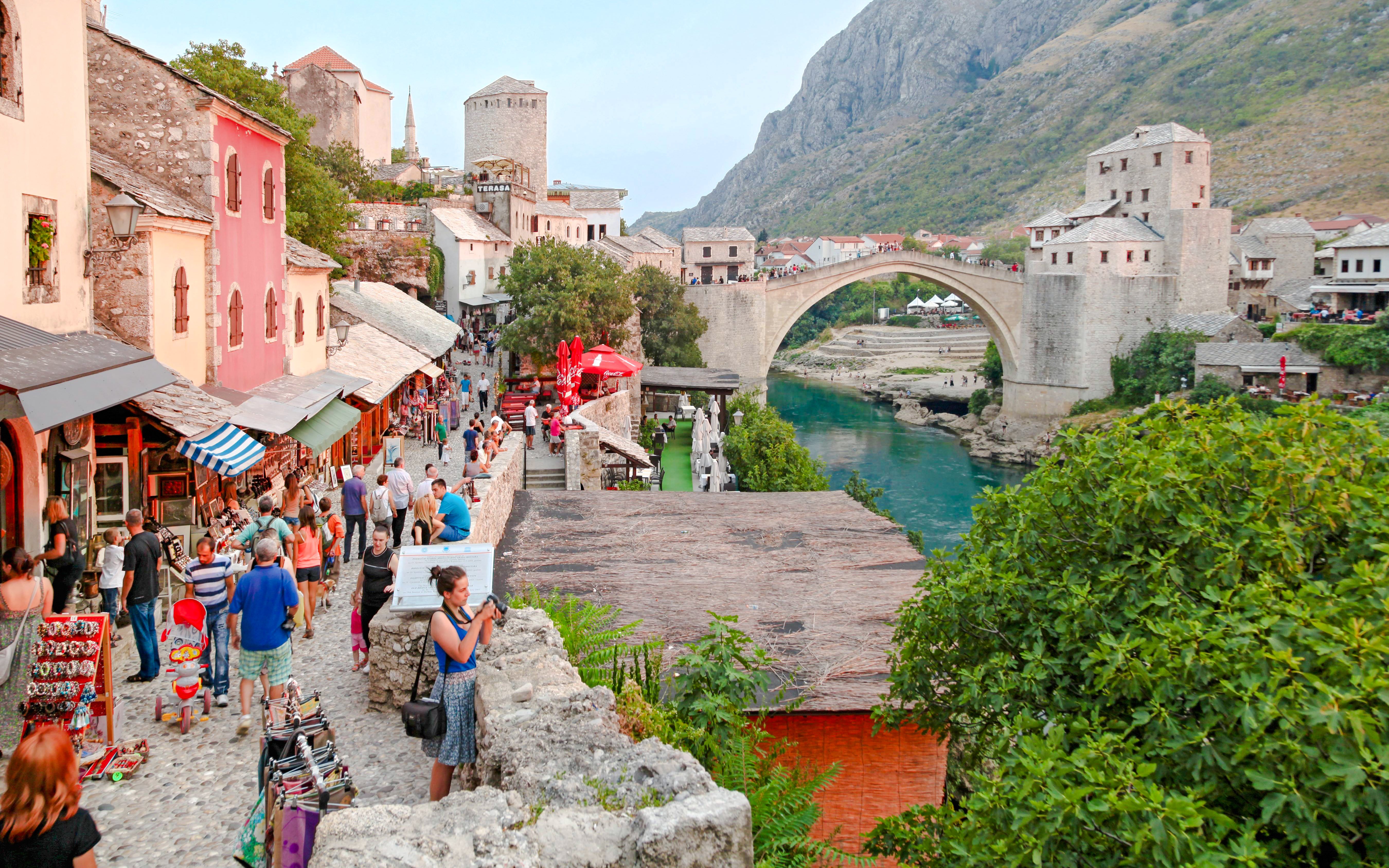 Crowded street market near the historic Old Bridge in Mostar, Bosnia and Herzegovina.