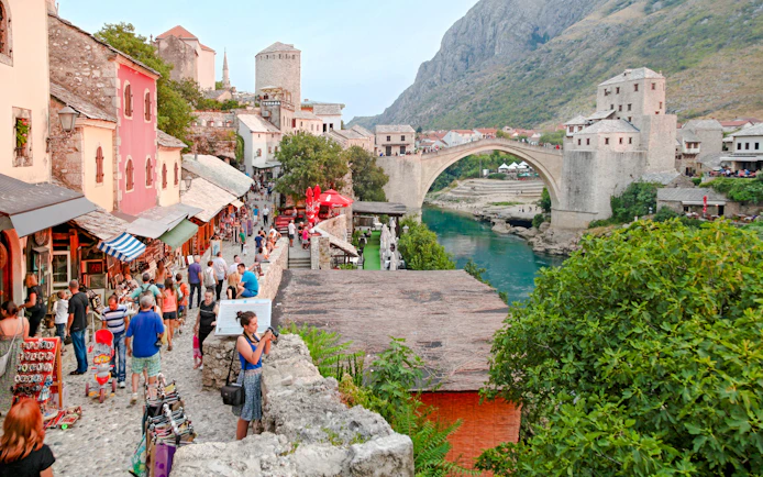 Crowded street market near the historic Old Bridge in Mostar, Bosnia and Herzegovina.