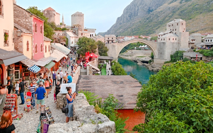 Crowded street market near the historic Old Bridge in Mostar, Bosnia and Herzegovina.