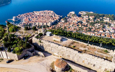 Fort Imperial atop Mount Srđ overlooking Dubrovnik, Croatia, with city and sea views.