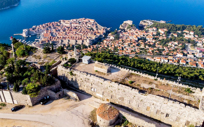 Fort Imperial atop Mount Srđ overlooking Dubrovnik, Croatia, with city and sea views.
