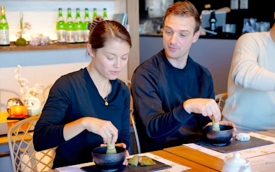 Husband and wife making matcha with Japanese sweets in Tokyo.