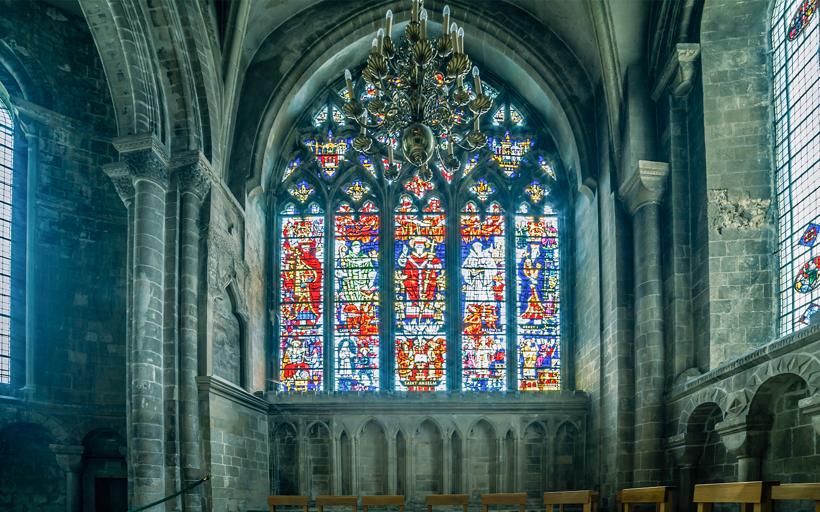 Stained glass windows inside Canterbury Cathedral, showcasing intricate medieval designs.