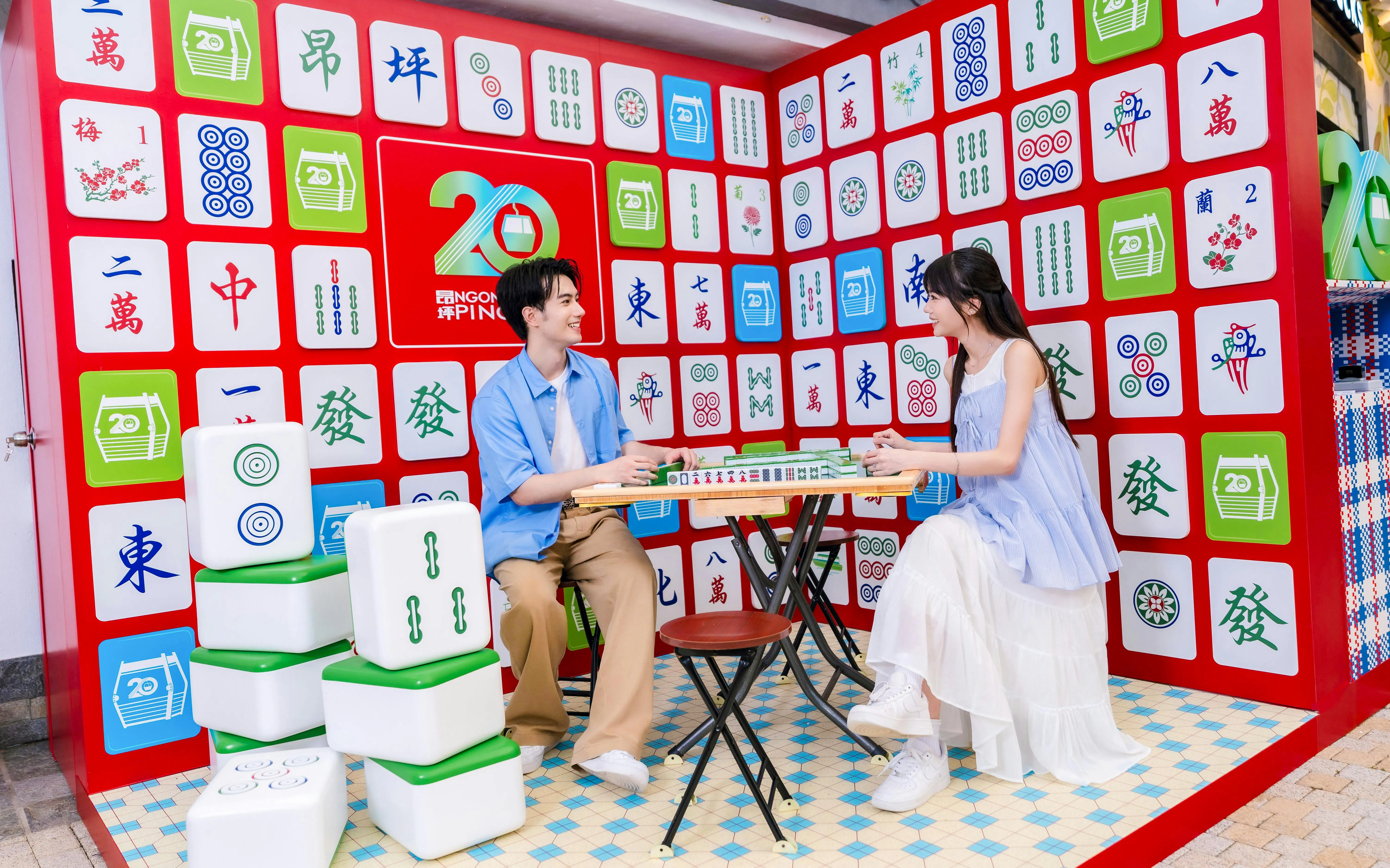 Couple playing mahjong at Ngong Ping 360 attraction on Lantau Island.