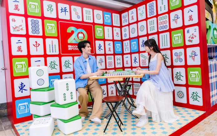 Couple playing mahjong at Ngong Ping 360 attraction on Lantau Island.
