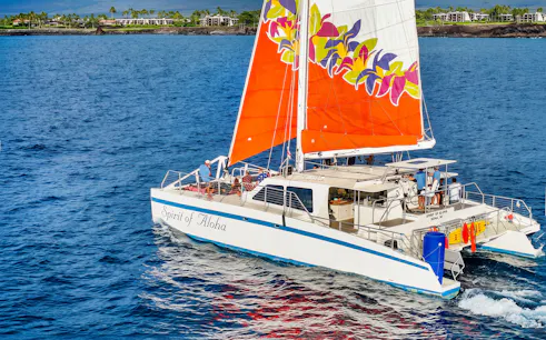 Catamaran sailing near Waikoloa on Big Island with vibrant sails.