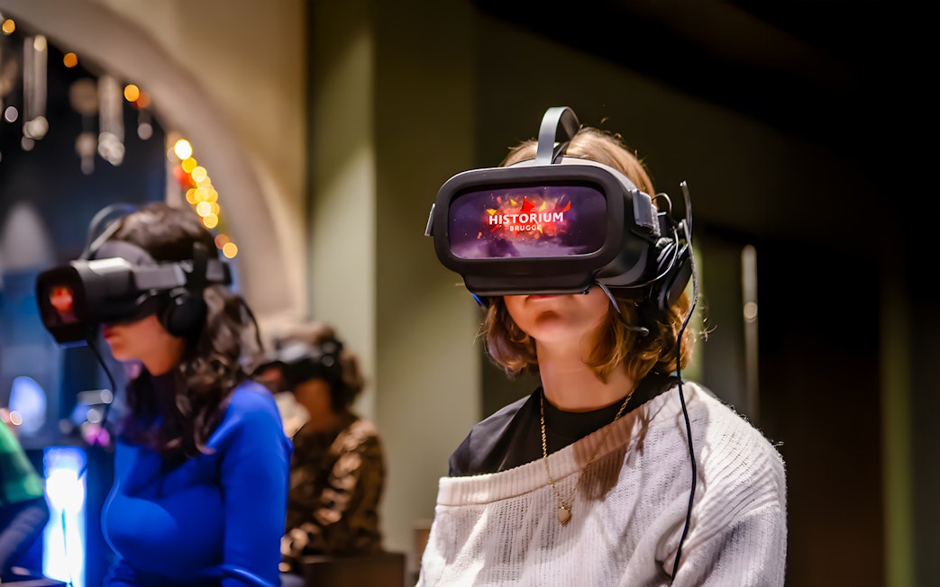 Visitors using VR headsets at Historium Bruges experience.