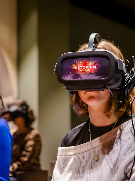 Visitors using VR headsets at Historium Bruges experience.