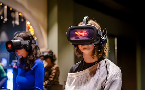 Visitors using VR headsets at Historium Bruges experience.