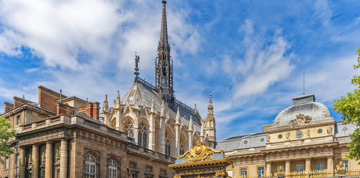 Sainte Chapelle's Gothic spire and ornate facade in Paris, France.