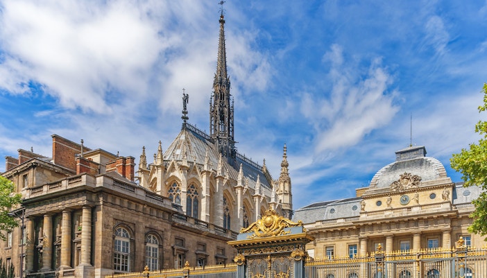 Visitors exploring the stunning stained glass windows of Sainte Chapelle in Paris, a unique feature of this guided tour