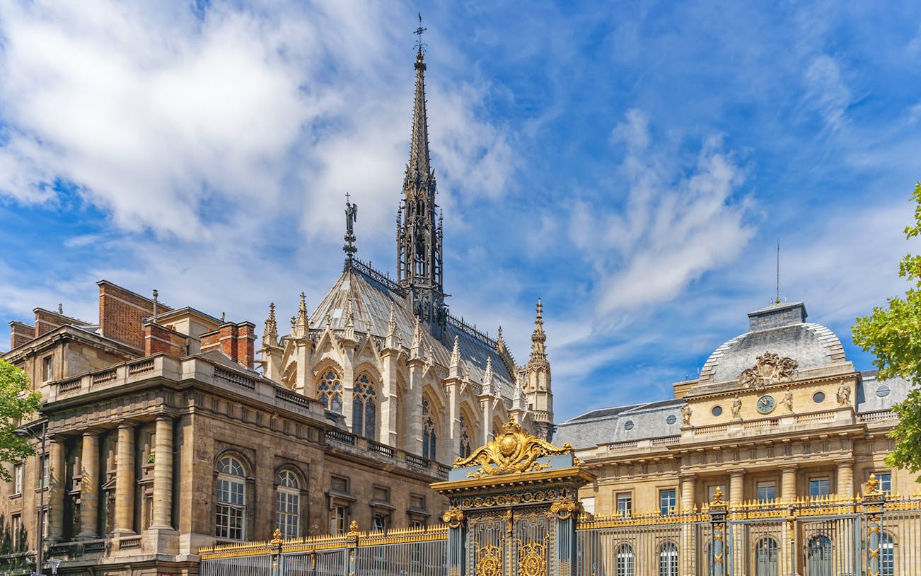 Sainte Chapelle's Gothic spire and ornate facade in Paris, France.