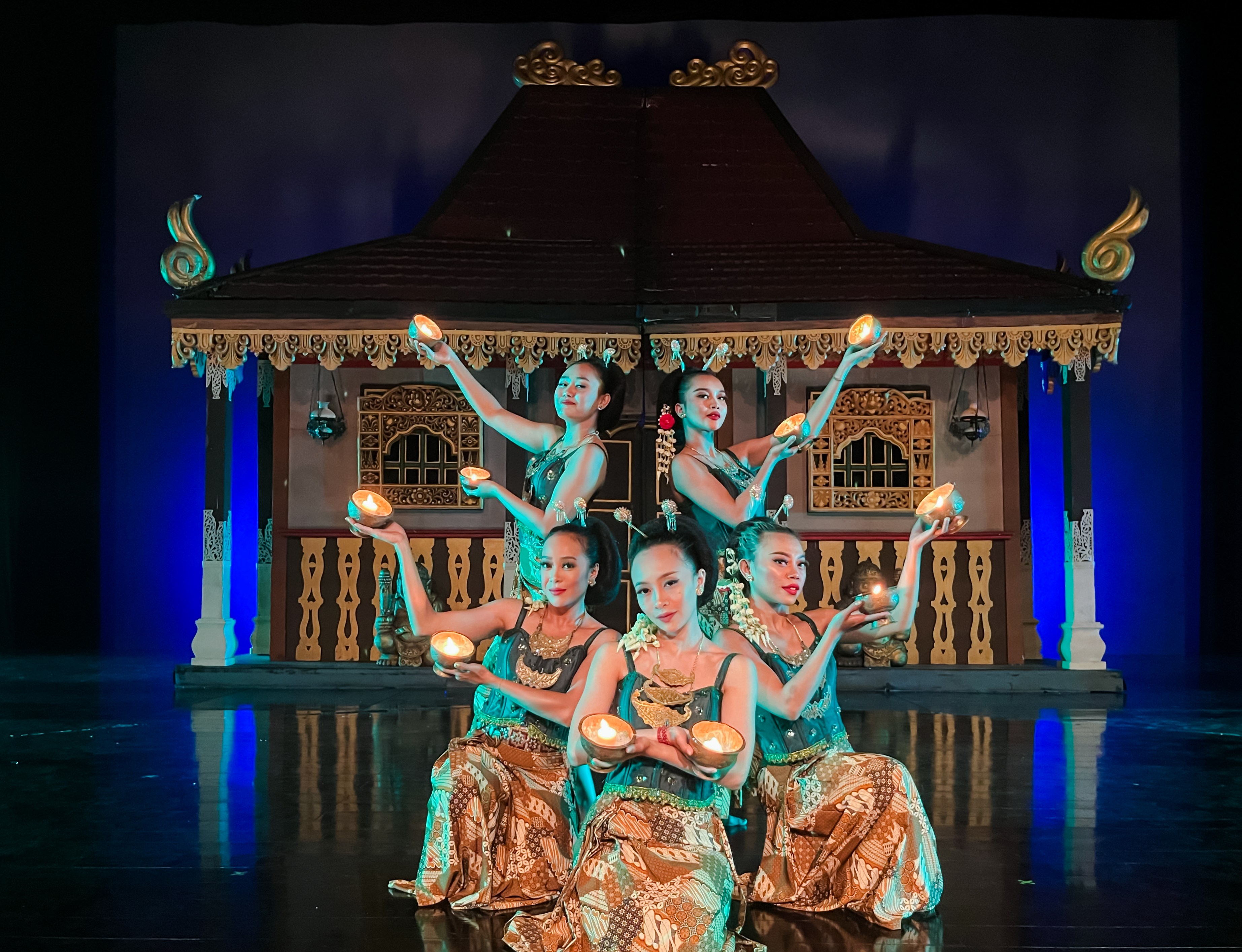 Performers at Devdan Show in Bali, presenting traditional Indonesian dance with lit props.