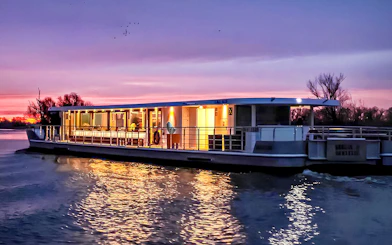 Berlin evening cruise boat on river at sunset.