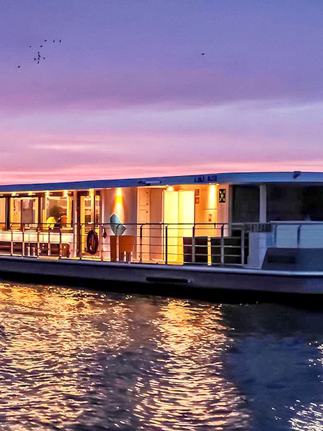 Berlin evening cruise boat on river at sunset.
