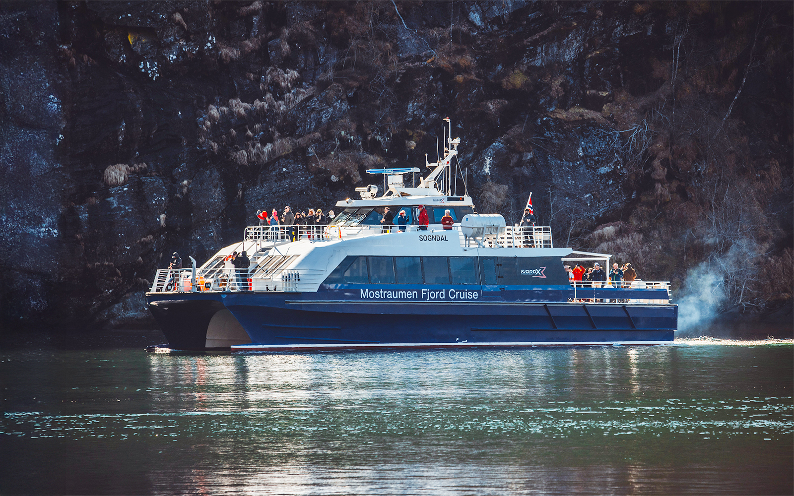 People enjoying the Mostraumen Fjord Cruise in Norway.