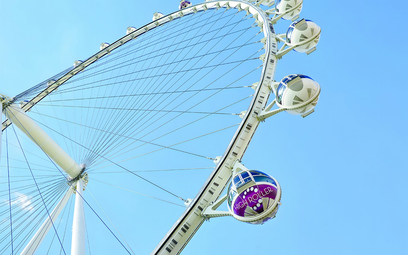 High Roller Wheel in Las Vegas against a clear blue sky.