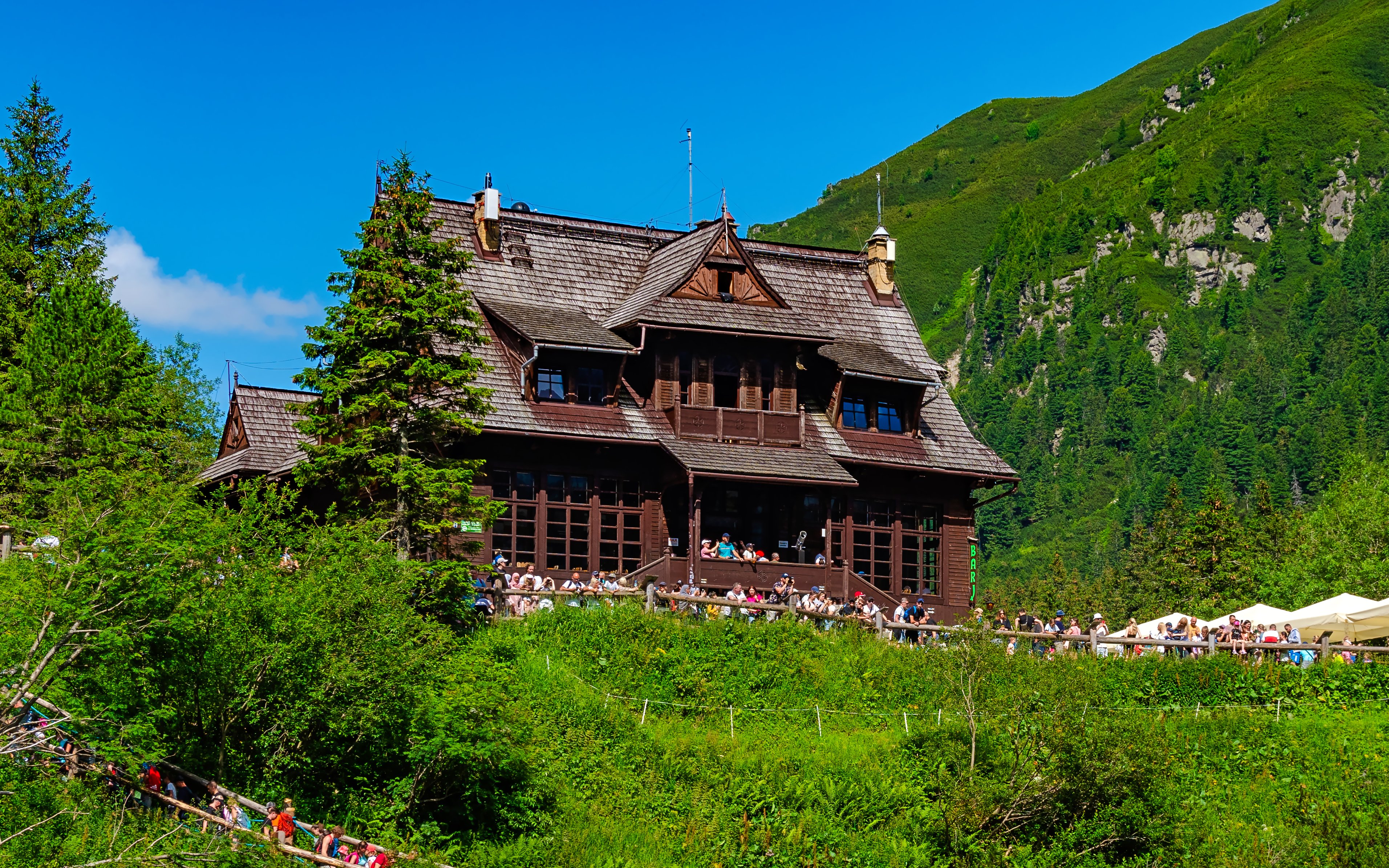 Mountain hut surrounded by greenery at Morskie Oko, Poland.