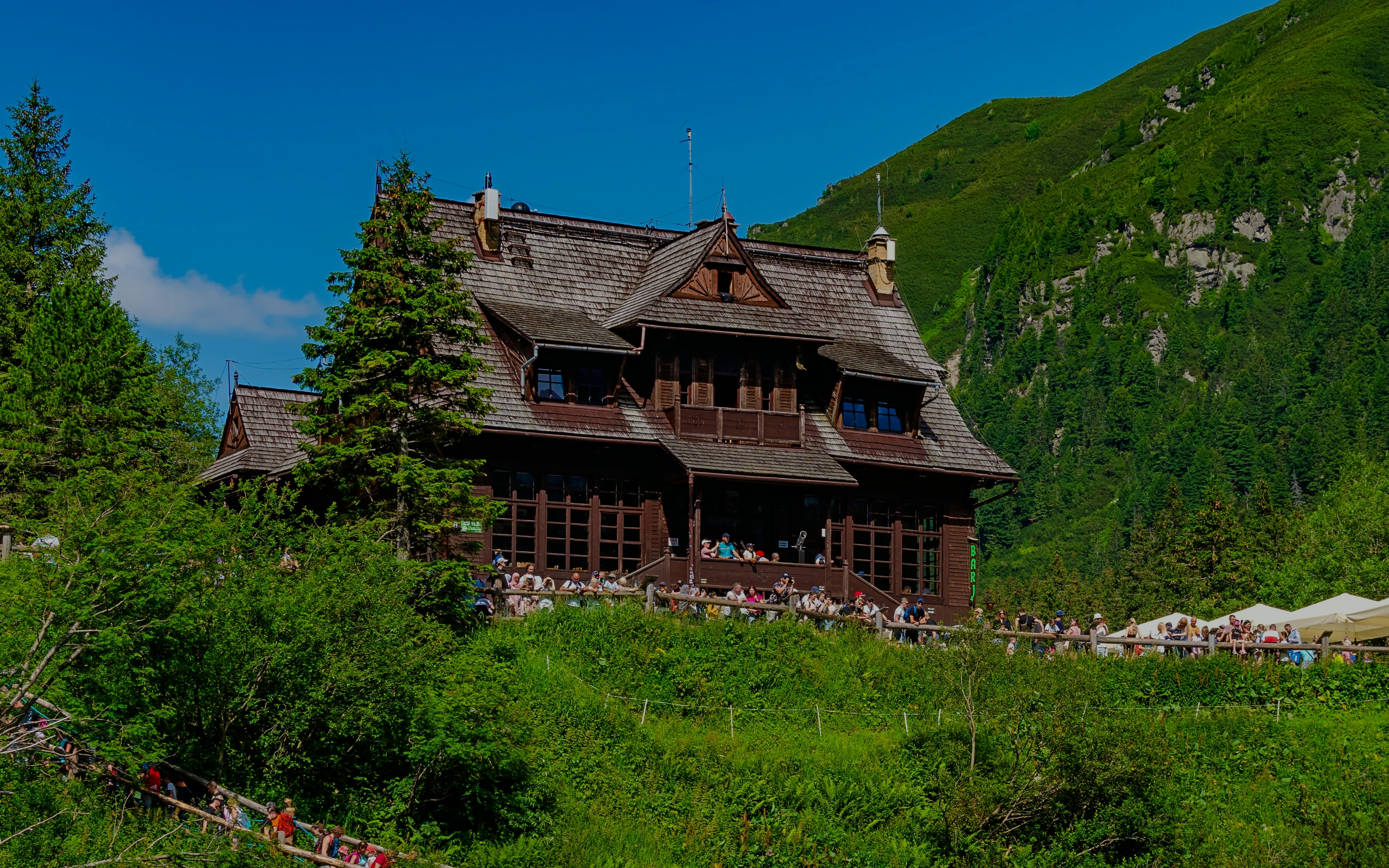 Mountain hut surrounded by greenery at Morskie Oko, Poland.
