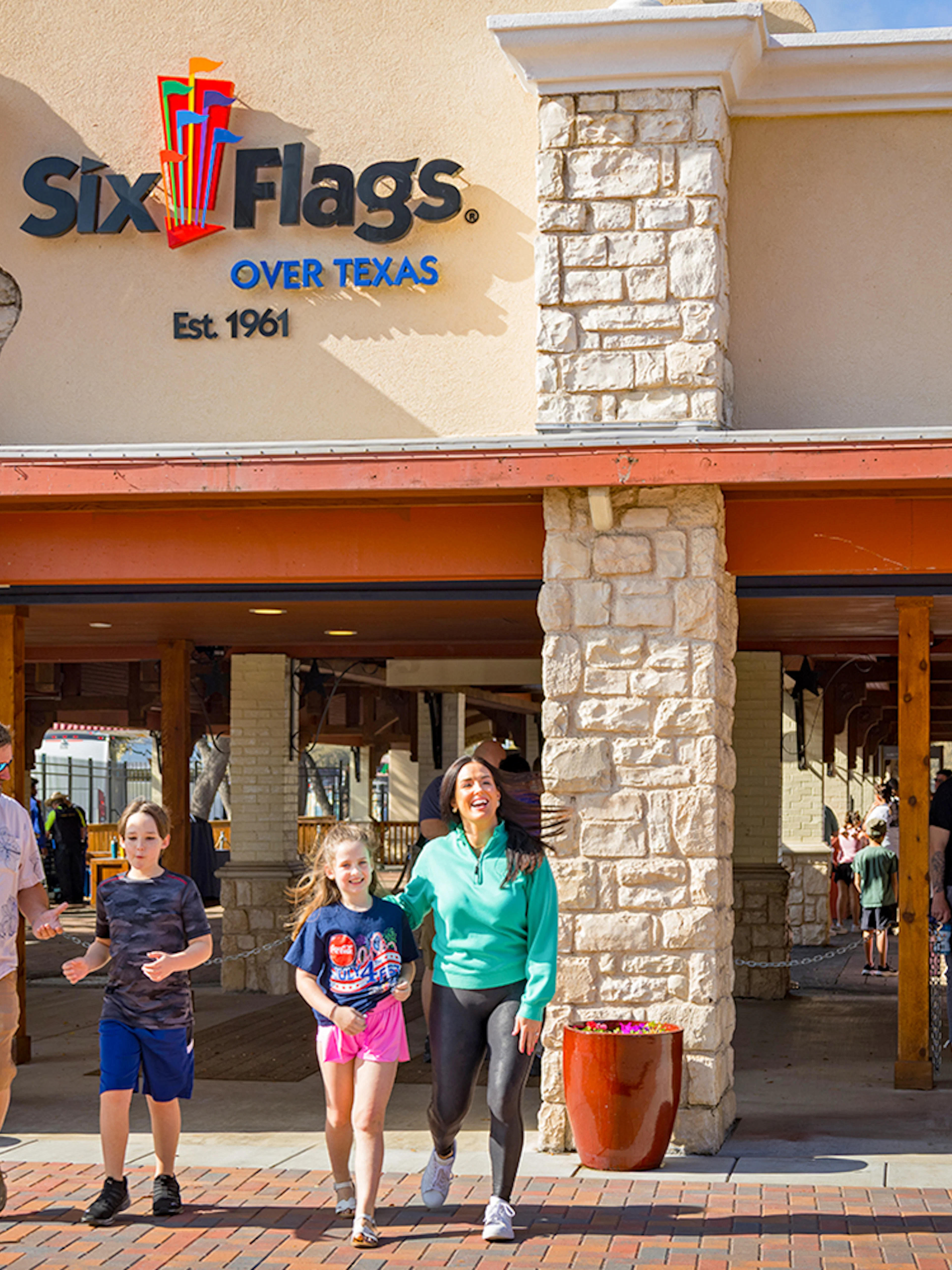 Visitors entering Six Flags Over Texas through the main gate.