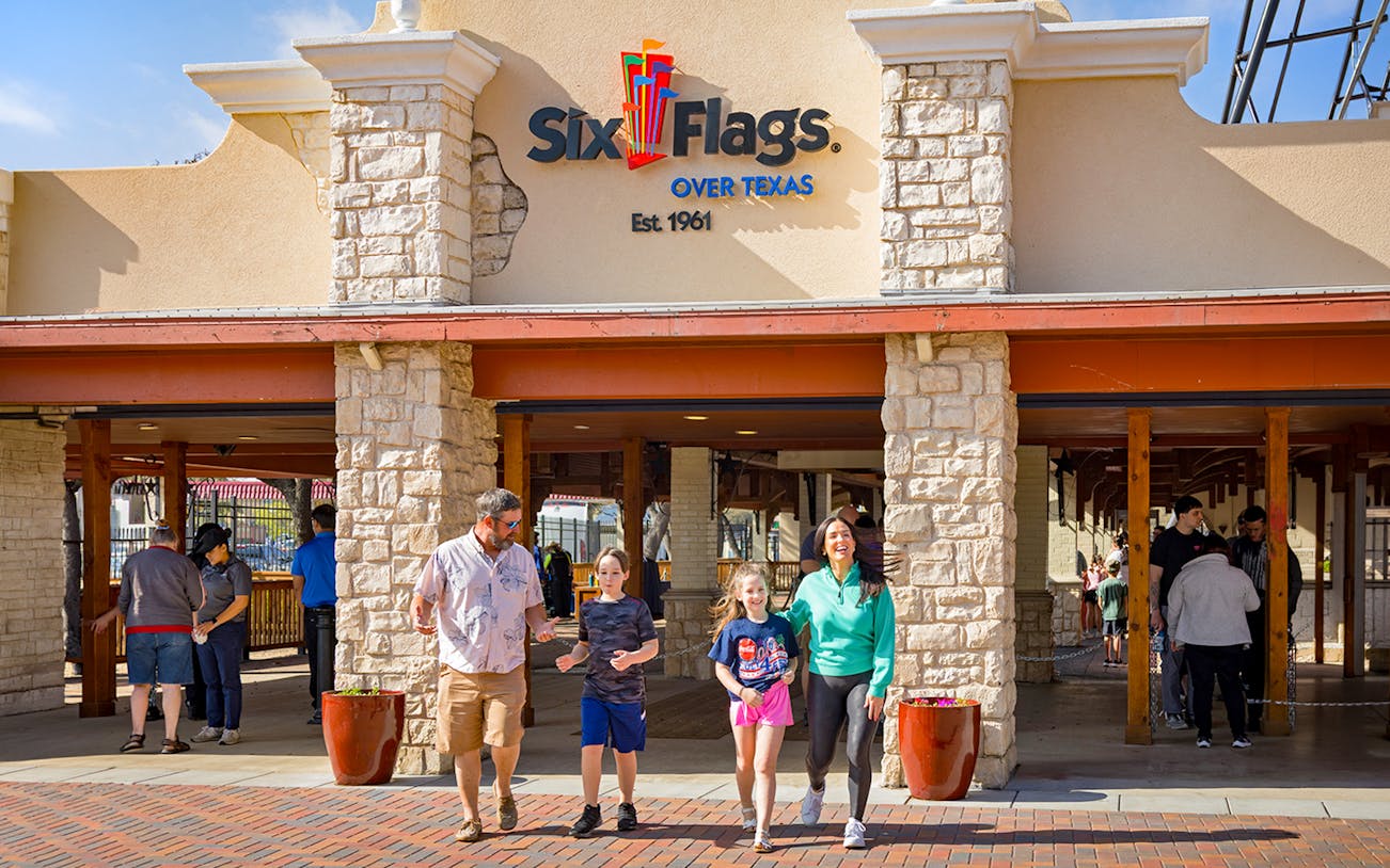 Visitors entering Six Flags Over Texas through the main gate.