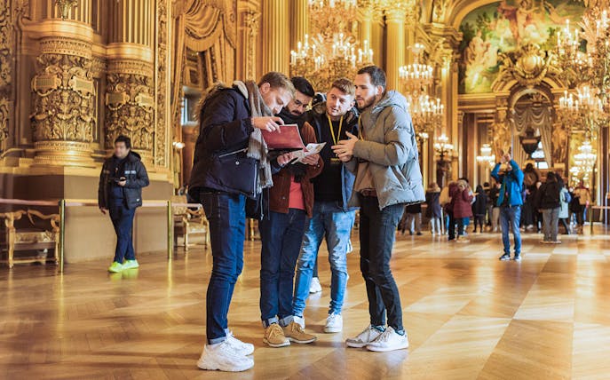 Visitors engage in the Arsene Lupin Immersive Game at Garnier Opera, Paris.