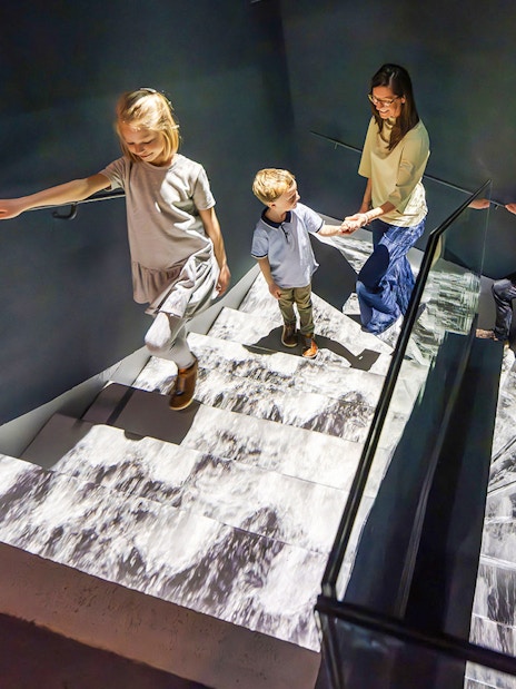 Guests exploring stairs at Praga Magica Interactive Exhibition.