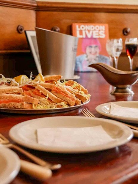 Sandwich platter and drinks on a table during Eating London: Heart of 'The City' Food Tour.