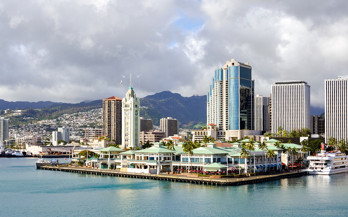 Honolulu Harbor Marina with Aloha Tower at Pier 9, cruise ship docked nearby.