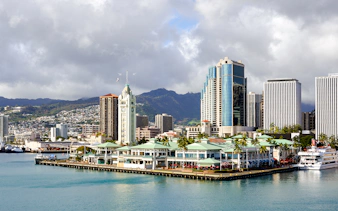 Honolulu Harbor Marina with Aloha Tower at Pier 9, cruise ship docked nearby.
