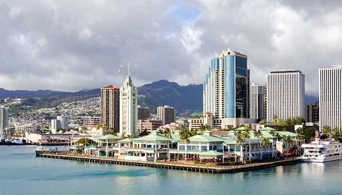 Honolulu Harbor Marina with Aloha Tower at Pier 9, cruise ship docked nearby.
