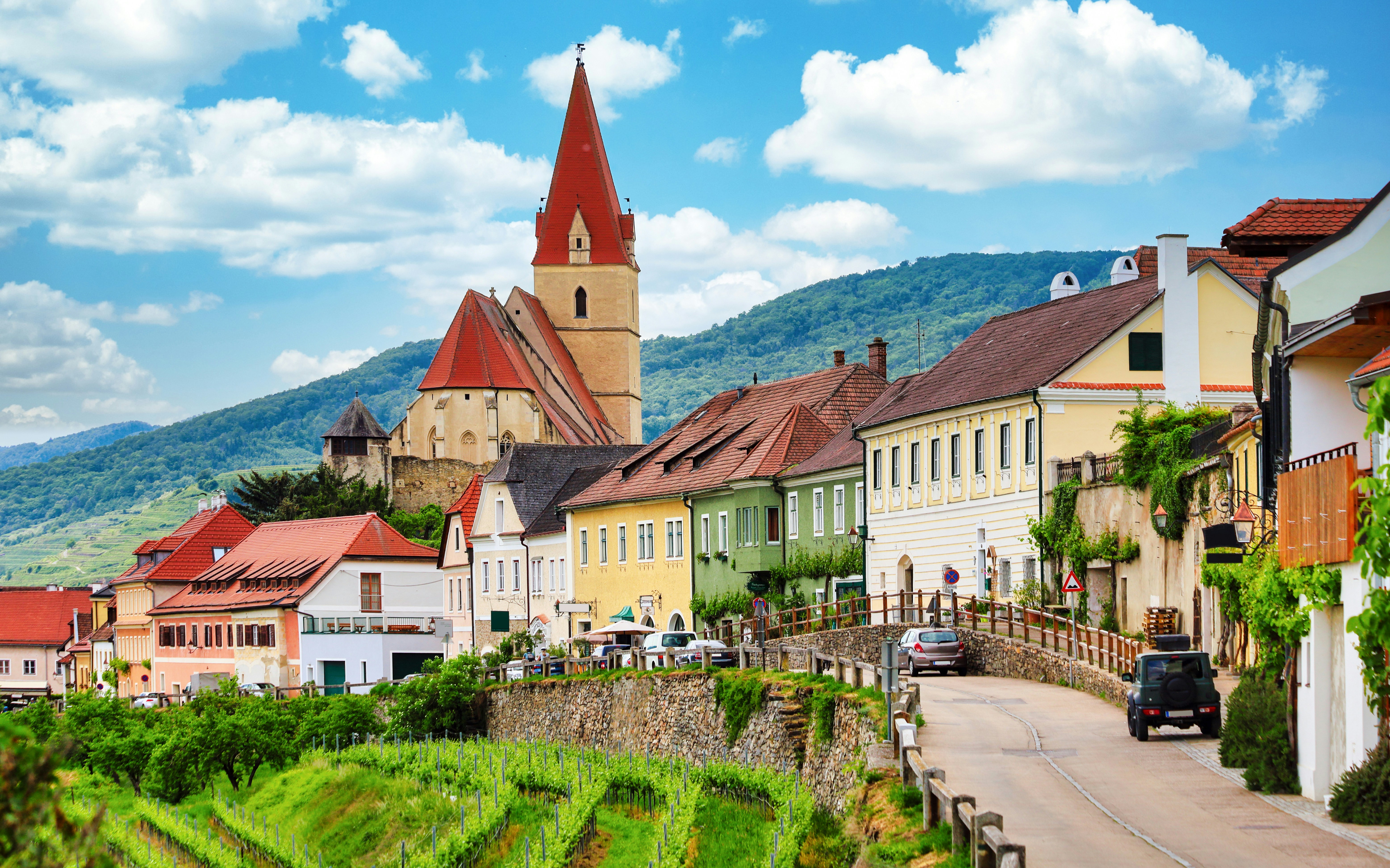 Historic village Weissenkirchen with colorful houses and church tower, Austria.
