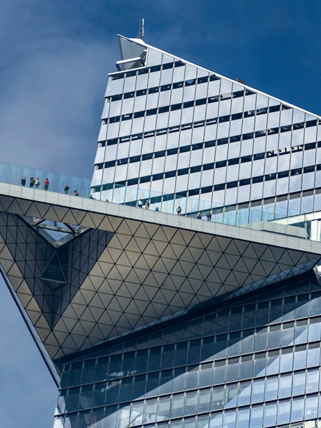 Edge observation deck with visitors on glass platform, New York City.