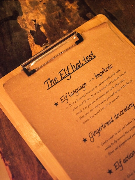 Elf Hat Academy test instructions on clipboard at Santa's Village.