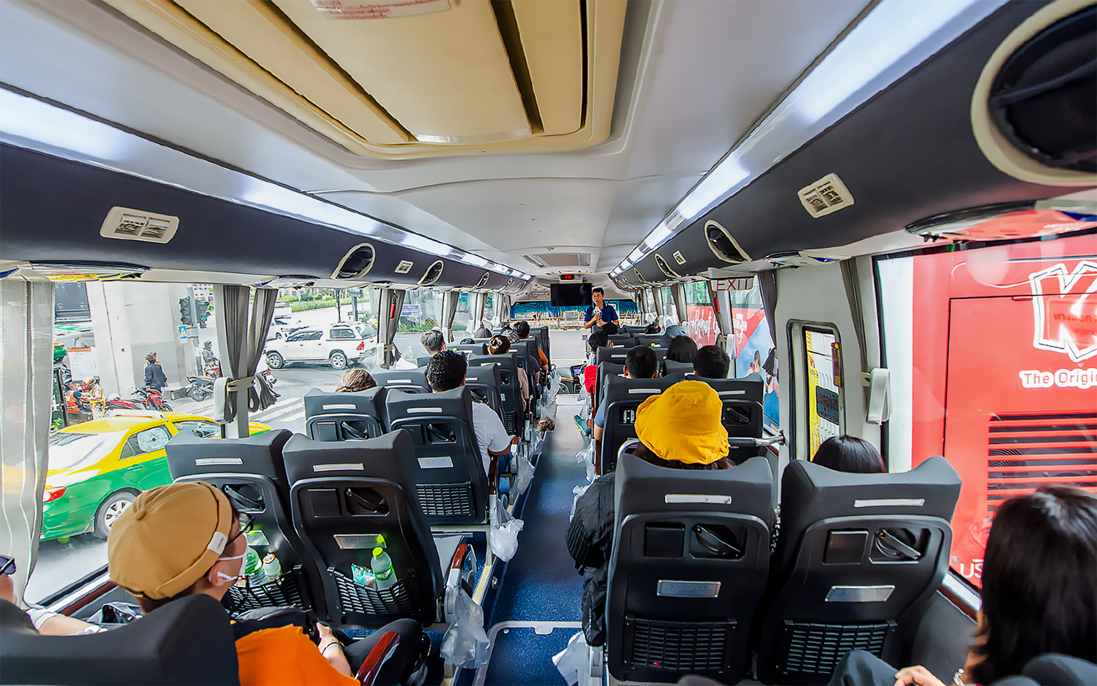 Passengers seated inside an AC coach during Ayutthaya Temples guided half-day tour.