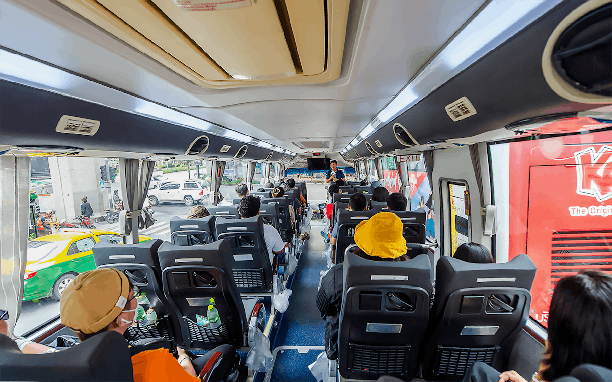 Passengers seated inside an AC coach during Ayutthaya Temples guided half-day tour.