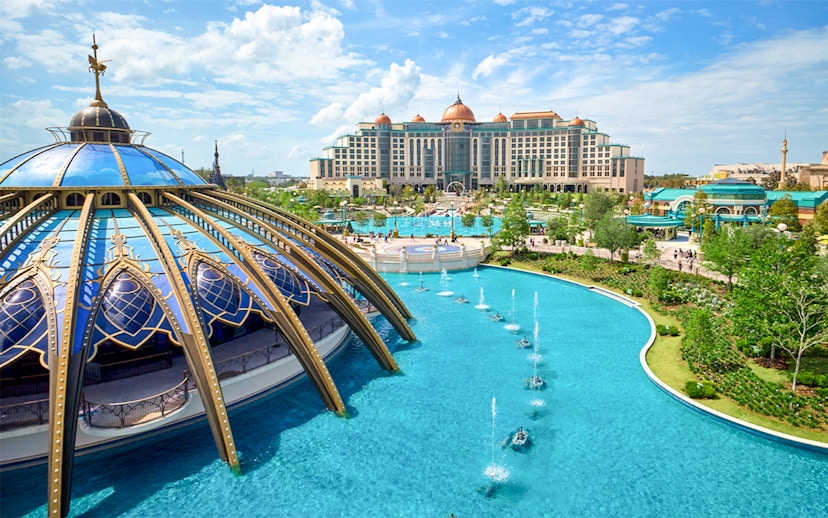 Epic Universe park in Universal Orlando with dome structure and fountains.