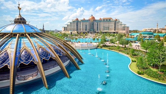 Epic Universe park in Universal Orlando with dome structure and fountains.