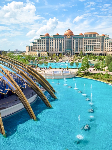 Epic Universe park in Universal Orlando with dome structure and fountains.