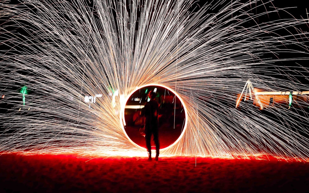 Steel wool fire show during overnight desert safari in Abu Dhabi.