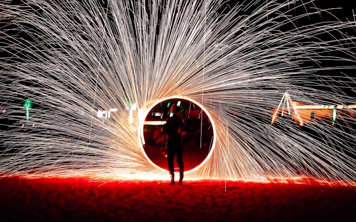 Steel wool fire show during overnight desert safari in Abu Dhabi.