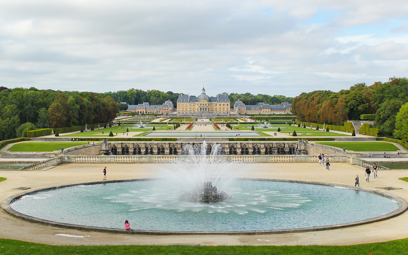 Vaux-le-Vicomte gardens with central fountain and chateau in the background, near Paris.