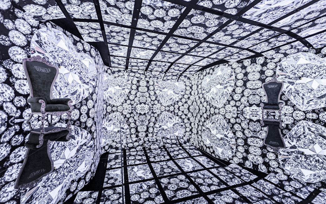 MIRACLEWORLD Osaka room with diamond-patterned walls and two ornate chairs.