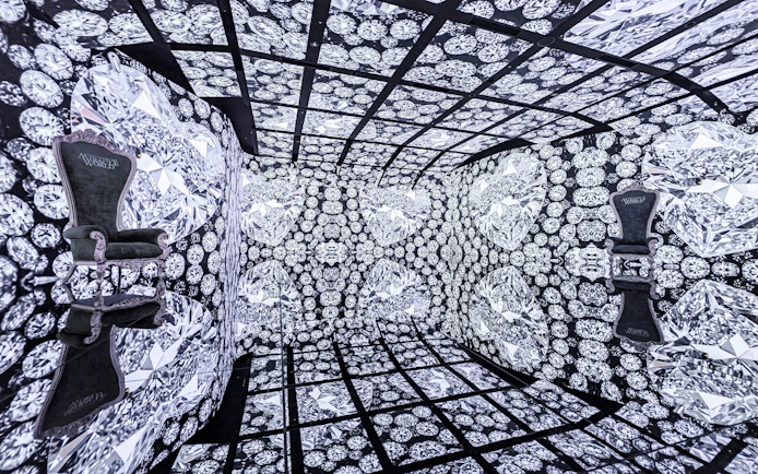 MIRACLEWORLD Osaka room with diamond-patterned walls and two ornate chairs.
