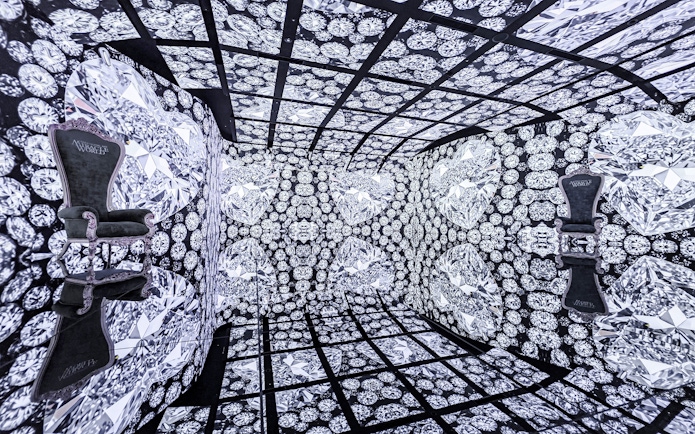MIRACLEWORLD Osaka room with diamond-patterned walls and two ornate chairs.