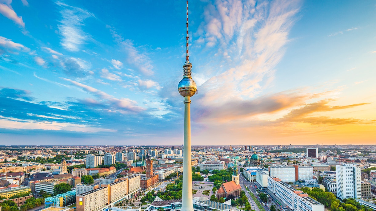 Berlin TV Tower exterior with panoramic city views during sunset time.