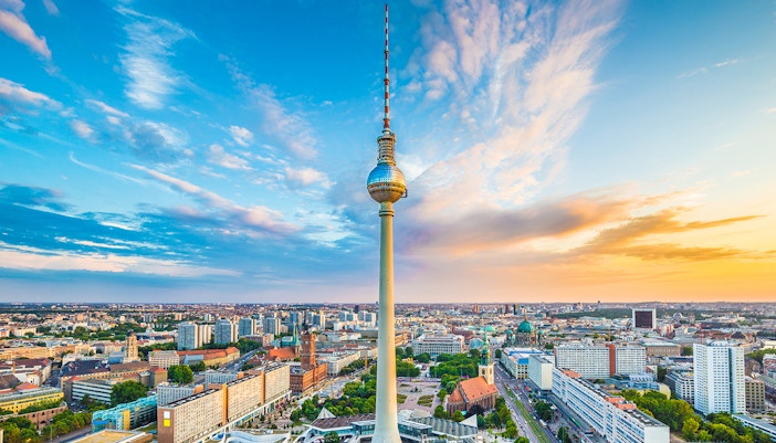 Berlin TV Tower overlooking cityscape at sunset, view from above.