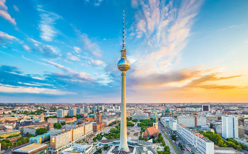 Berlin TV Tower overlooking cityscape at sunset, view from above.