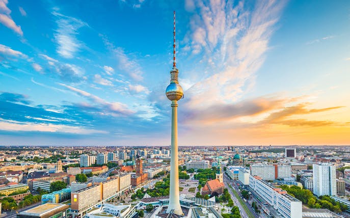 Berlin TV Tower overlooking cityscape at sunset, view from above.
