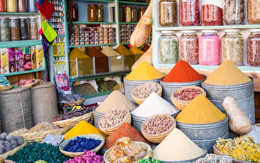 Spices and herbs displayed in Marrakesh Medina souk during guided walking tour.